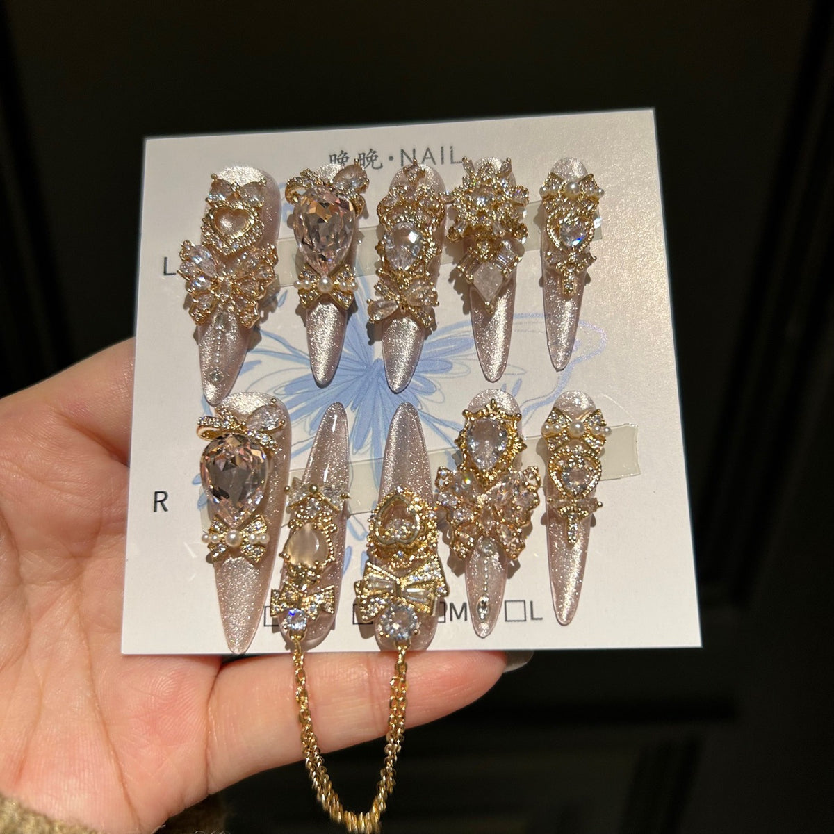 Champagne Pink Cat Eye Stiletto Press-on Nails with 3D Bowknot, Crystal Jewels, and Hanging Chain Charms - Luxury Statement Fake Nail Set
