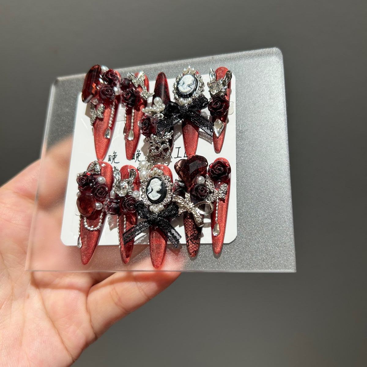 Handmade Metallic Red Long Stiletto Press On Nails with Vintage Cameo Portrait, 3D Dark Red Roses, Black Bows, Crystals & Pearl Chain Tassels