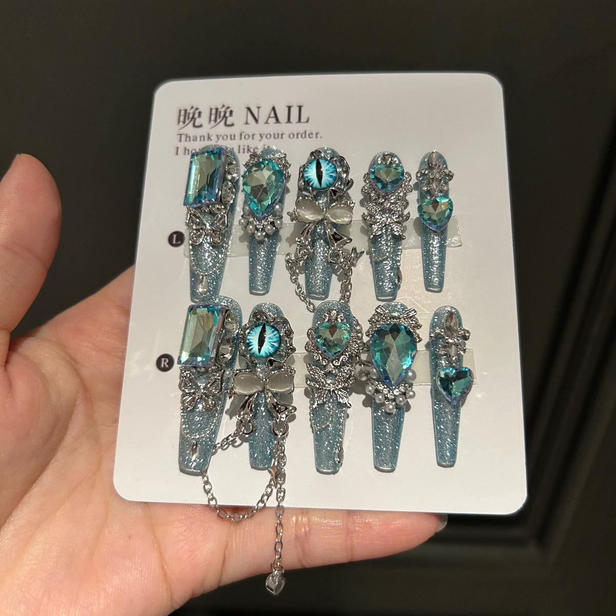 Icy Blue Cat Eye Coffin Press-on Nails with Oversized Iridescent Crystals, 3D Evil Eye, Bow, and Interlinked Chain - Y2K Cyber Glam Fake Nail Set