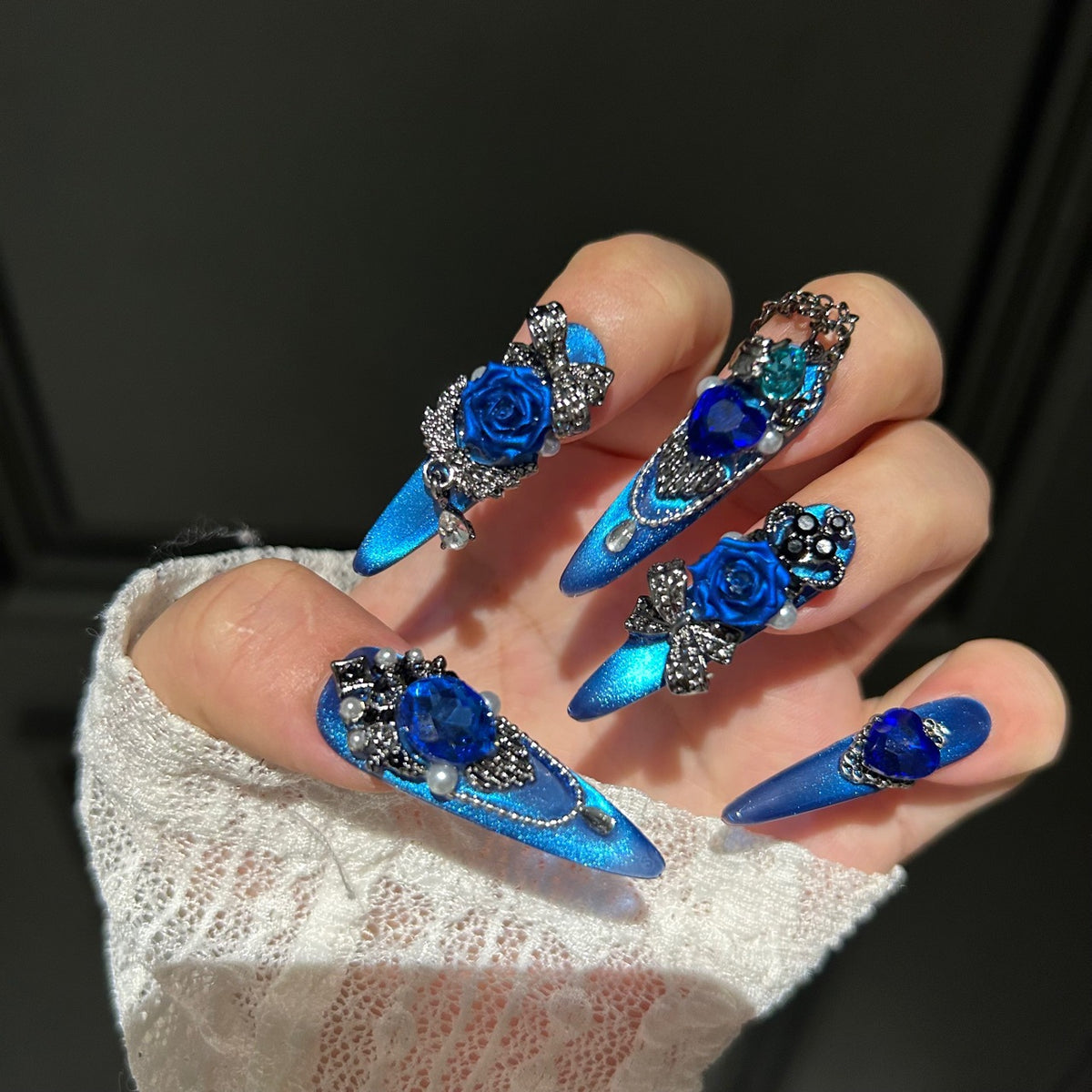 Handmade Electric Blue Cat Eye Long Stiletto Press On Nails with 3D Blue Roses, Giant Blue Heart Crystals, Rhinestone Crowns, Butterfly Charms & Dangling Chains