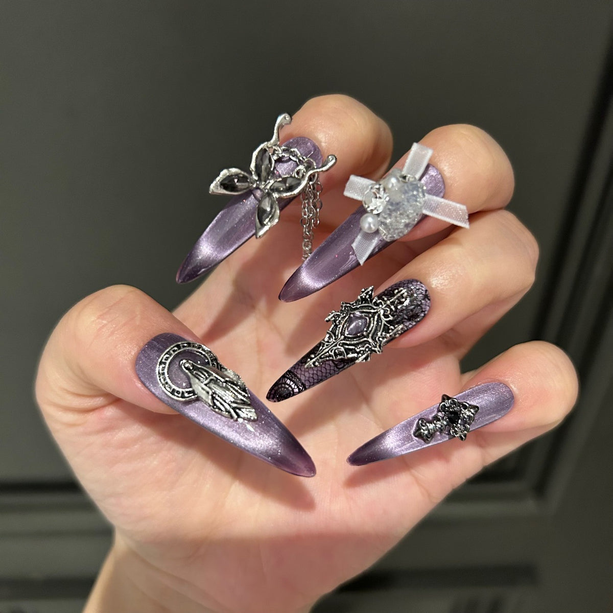 Dark Grey-Purple Cat Eye Stiletto Press-on Nails with Vintage Silver Religious Relief, Lace Pattern, White Ribbon Bow, Butterfly, and Draping Chain - Gothic Glam Fake Nail Set