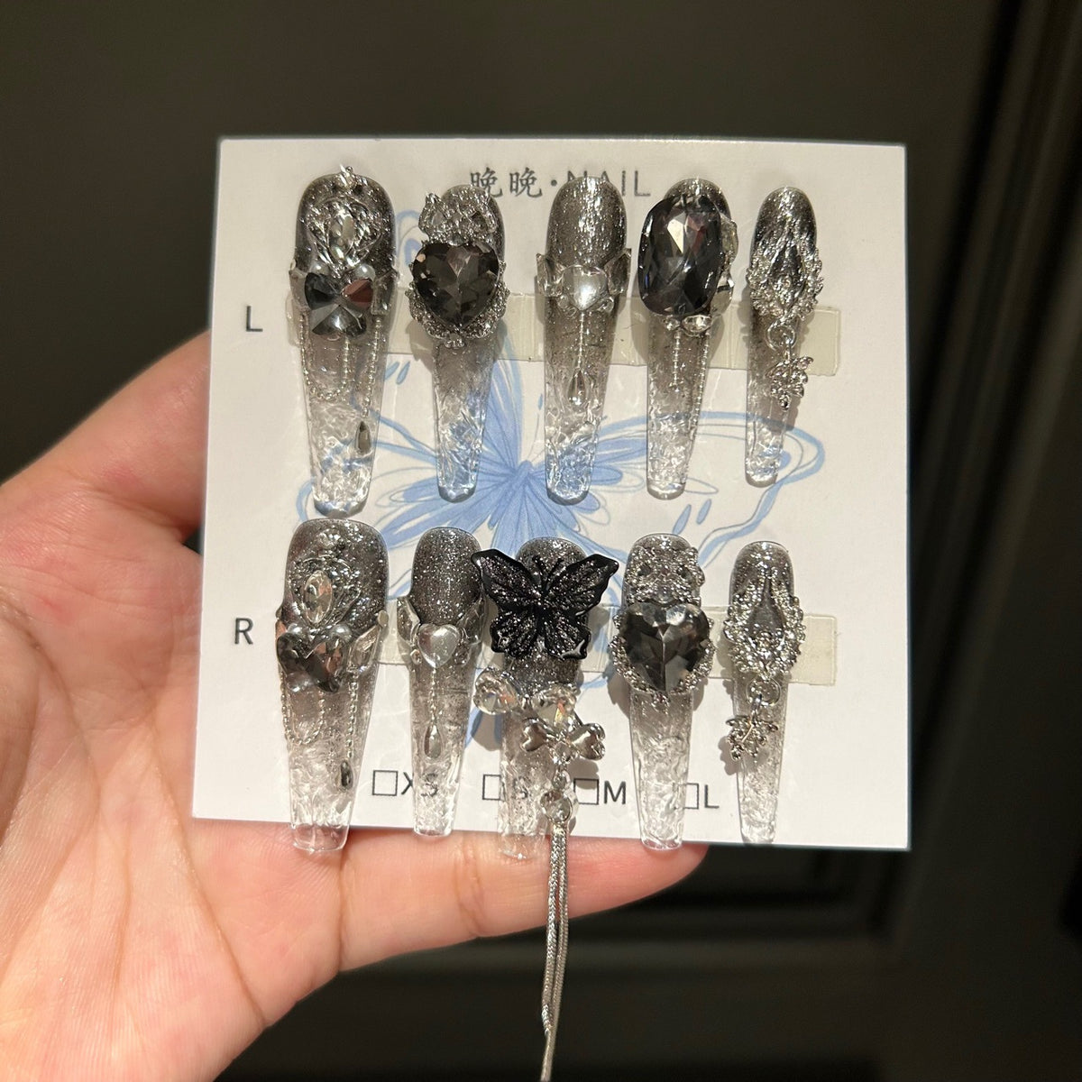 Handmade Clear Smoke Glitter Long Coffin Press On Nails with Giant Black Heart Crystals, Black Butterfly Charms, Silver Metal Ornaments & Dangling Tassel Chains