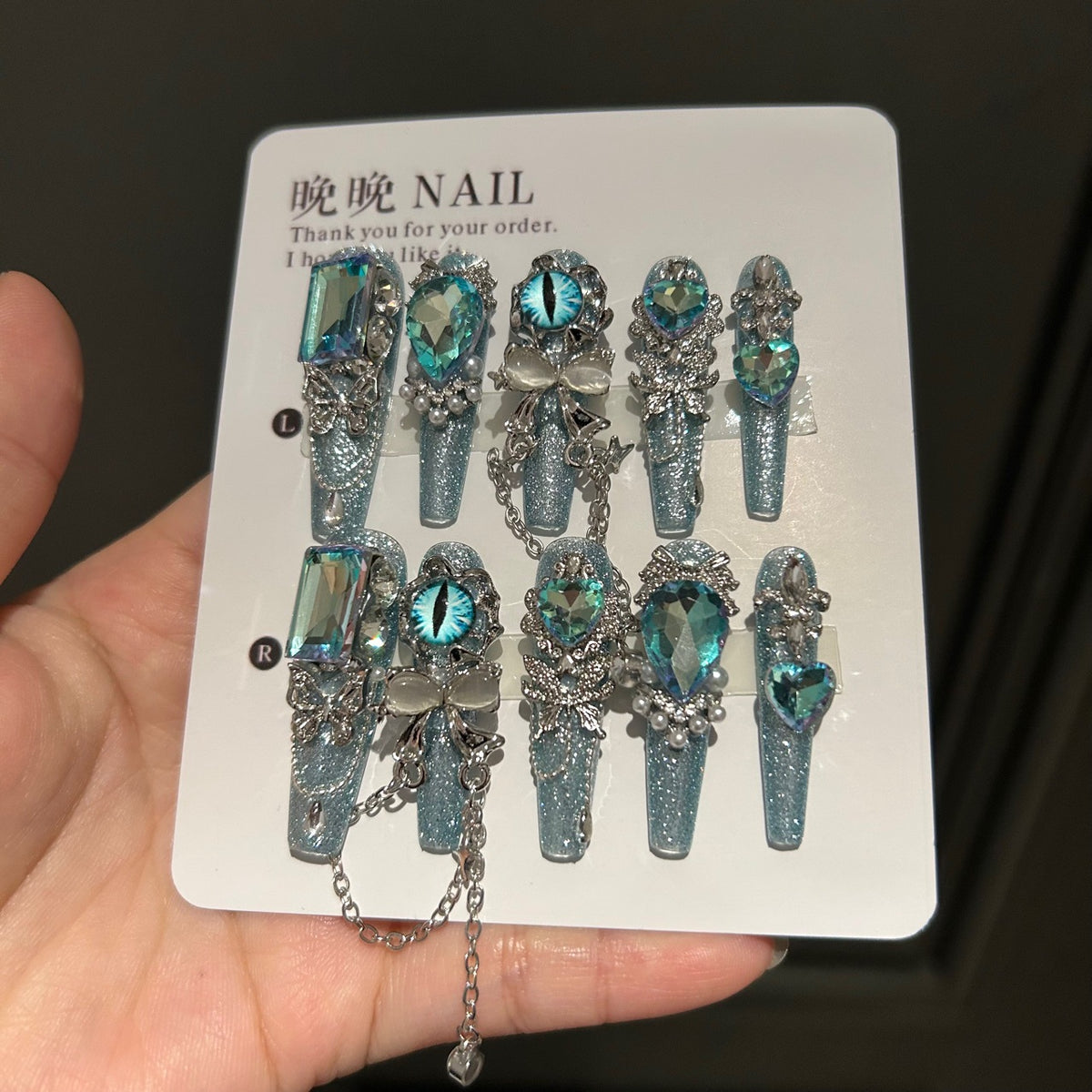 Icy Blue Cat Eye Coffin Press-on Nails with Oversized Iridescent Crystals, 3D Evil Eye, Bow, and Interlinked Chain - Y2K Cyber Glam Fake Nail Set