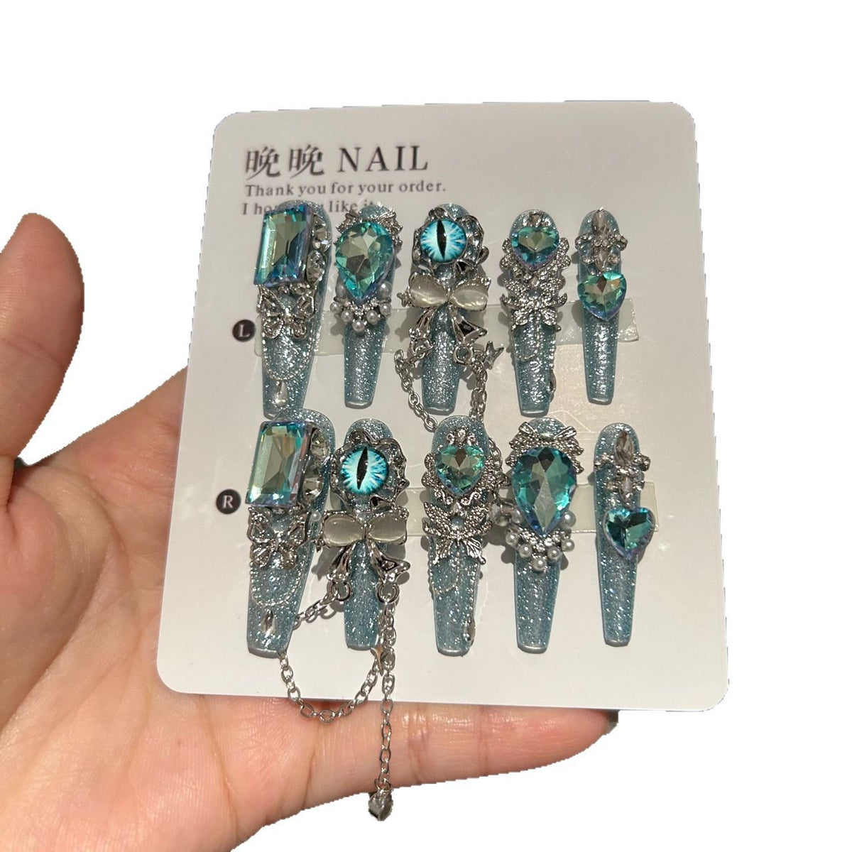 Icy Blue Cat Eye Coffin Press-on Nails with Oversized Iridescent Crystals, 3D Evil Eye, Bow, and Interlinked Chain - Y2K Cyber Glam Fake Nail Set