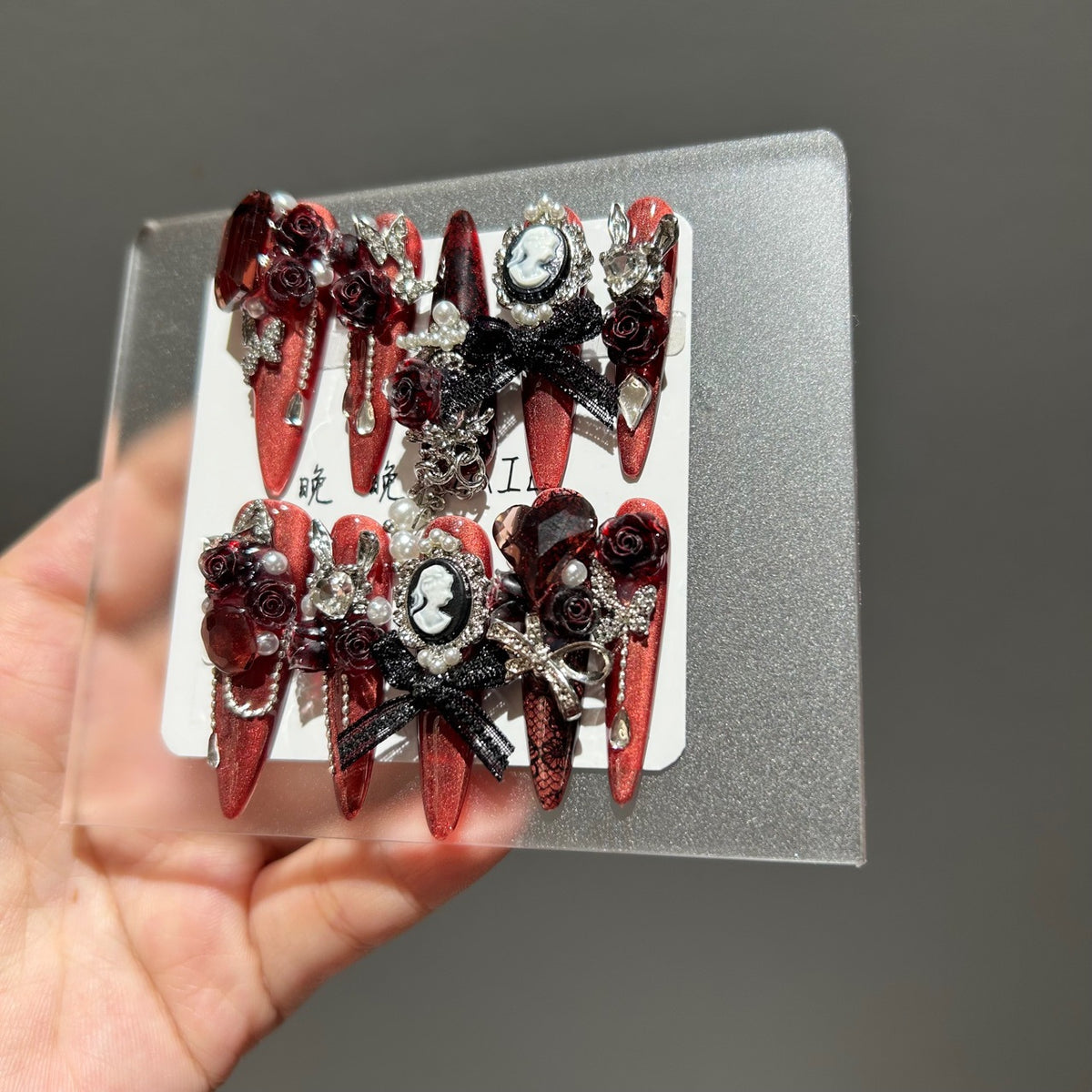 Handmade Metallic Red Long Stiletto Press On Nails with Vintage Cameo Portrait, 3D Dark Red Roses, Black Bows, Crystals & Pearl Chain Tassels