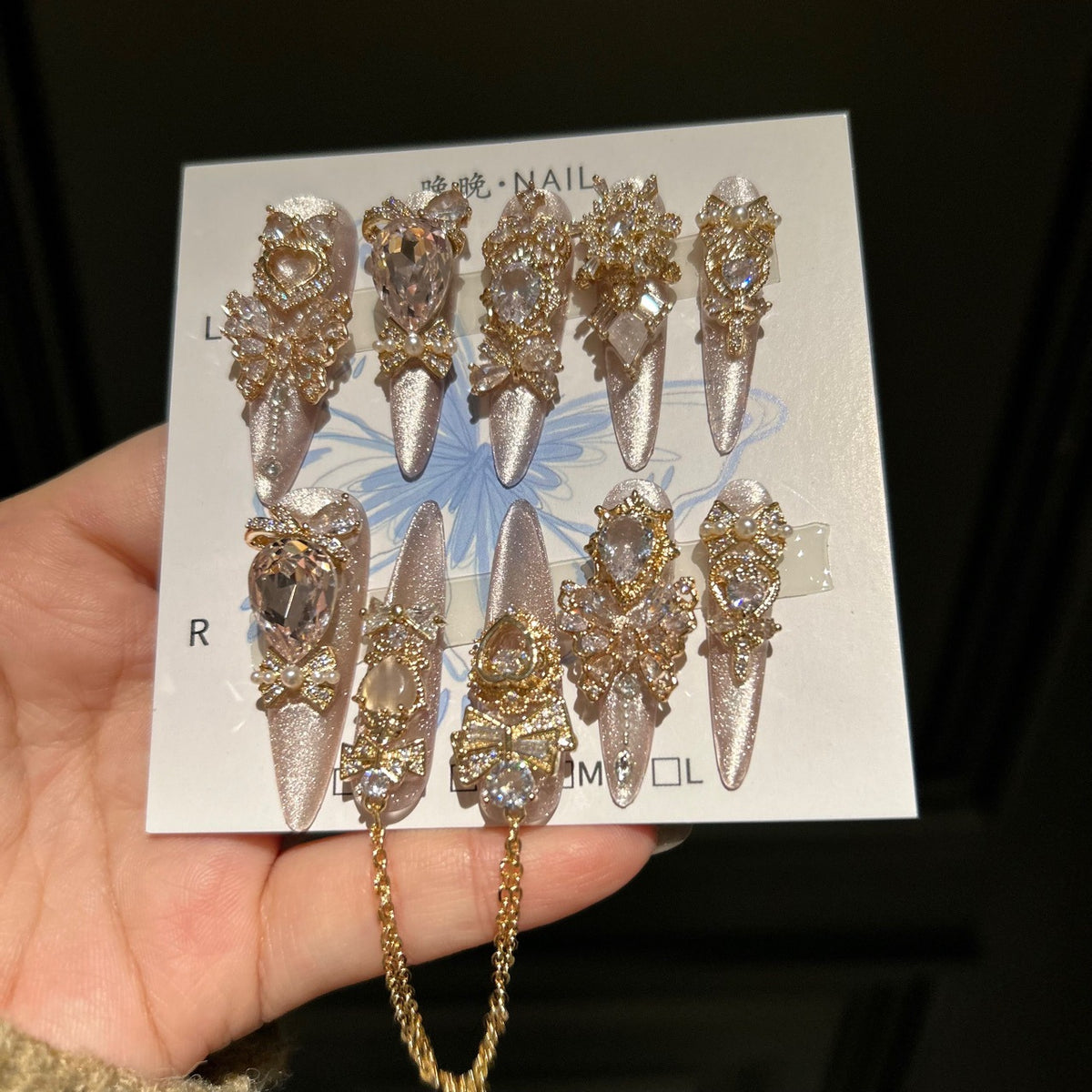Champagne Pink Cat Eye Stiletto Press-on Nails with 3D Bowknot, Crystal Jewels, and Hanging Chain Charms - Luxury Statement Fake Nail Set