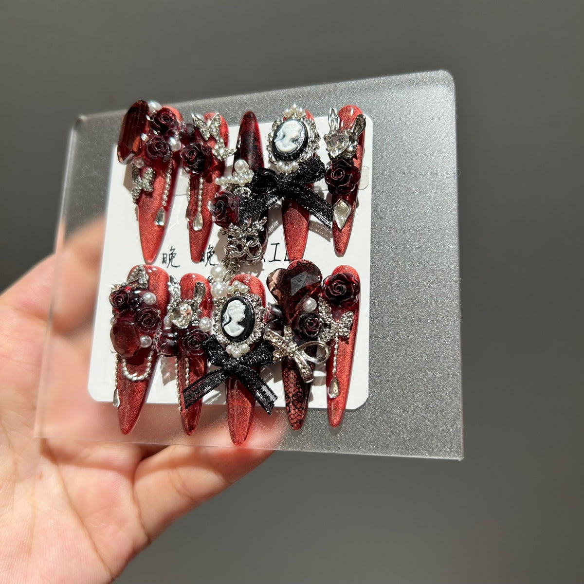 Handmade Metallic Red Long Stiletto Press On Nails with Vintage Cameo Portrait, 3D Dark Red Roses, Black Bows, Crystals & Pearl Chain Tassels