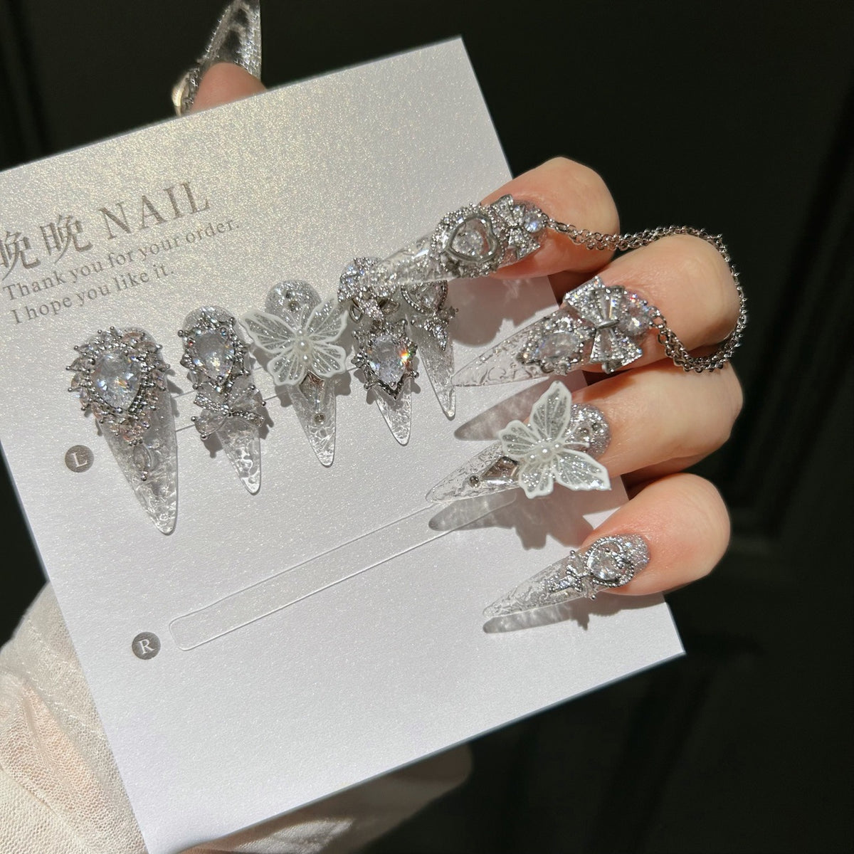 Handmade Silver Glitter Clear Long Stiletto Press On Nails with 3D White Butterfly Charms, Large Heart Crystals, Rhinestone Bows & Dangling Chains