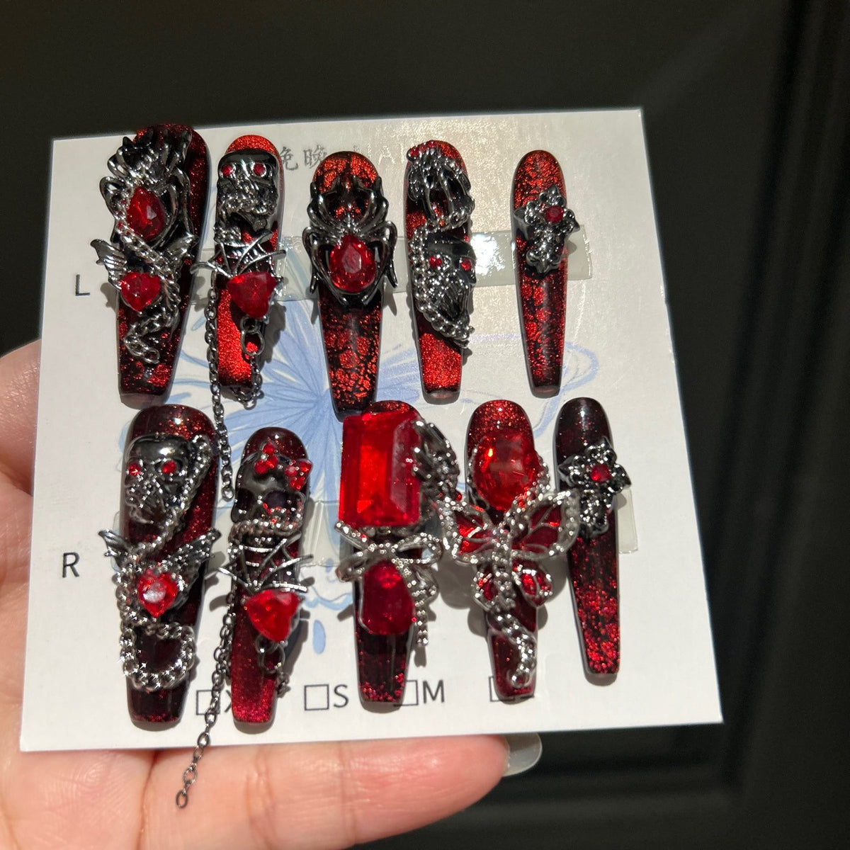Handcrafted Designer Dark Aesthetic Press-on Nails - Shimmering Red-Black Base with Heavy 3D Gemstones, Skull Art and Chain Drops