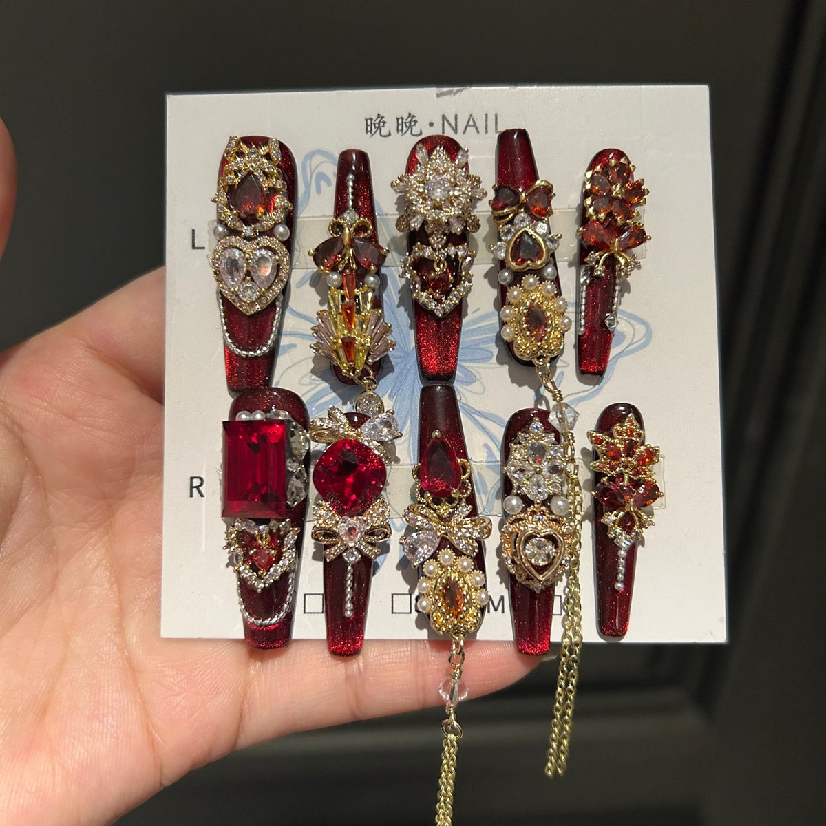 Handcrafted Designer Ruby Press-on Nails - Shimmering Cat Eye Base with Heavy 3D Red Gemstones, Gold Filigree and Chain Drops