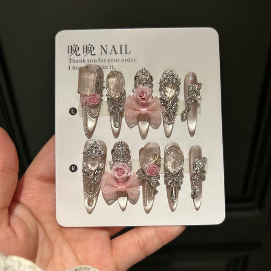 Champagne Nude Cat Eye Stiletto Press-on Nails with Oversized Crystals, 3D Pink Rose, Sheer Bow, Crown, and Crystal Draping Charm - Luxury Glam Fake Nail Set