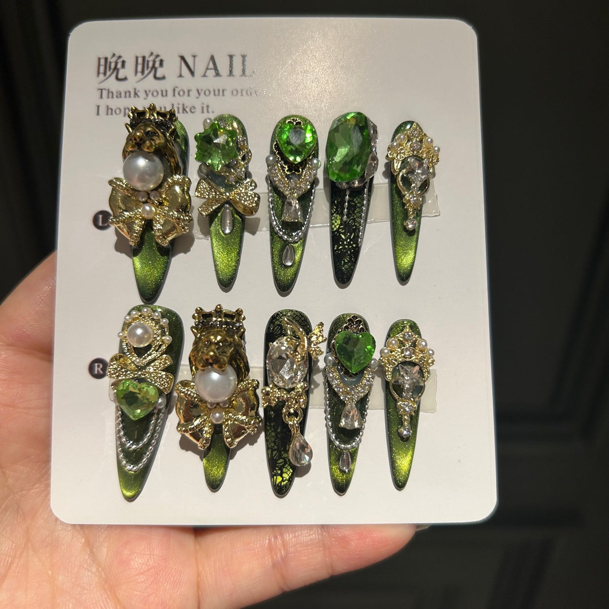 Handmade Green Cat Eye Press On Nails, Long Stiletto Royal Fantasy False Nails with Gold Lion Head & Crown Charms, Emerald Green Rhinestones, Pearls, Gold Bows & Dangling Silver Chains, Reusable Fake Nails for Party & Cosplay