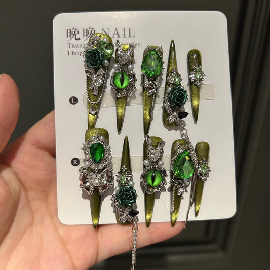 Handmade Olive Green Cat Eye Press On Nails, Long Stiletto Witch Fantasy False Nails with 3D Dark Green Roses, Green Devil Eye Charms, Emerald Rhinestones, Pearls, Silver Bows & Dangling Silver Chains, Reusable Fake Nails for Cosplay, Halloween & Party