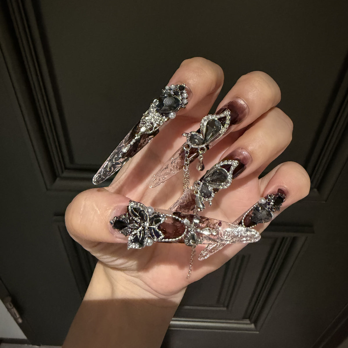 Handmade Dark Brown Smoky Long Stiletto Press On Nails, Gothic Black Butterfly False Nails with Heart Gems, Pearls & Dangling Chains