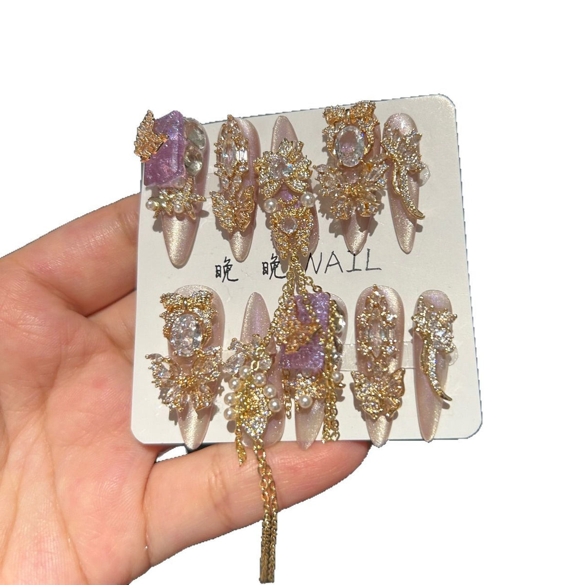 Champagne Pink & Purple Cat Eye Stiletto Press-on Nails with Purple Crystal Gem, Gold Rhinestone Bow, and Interlinked Hanging Chain - Luxury Glam Fake Nail Set