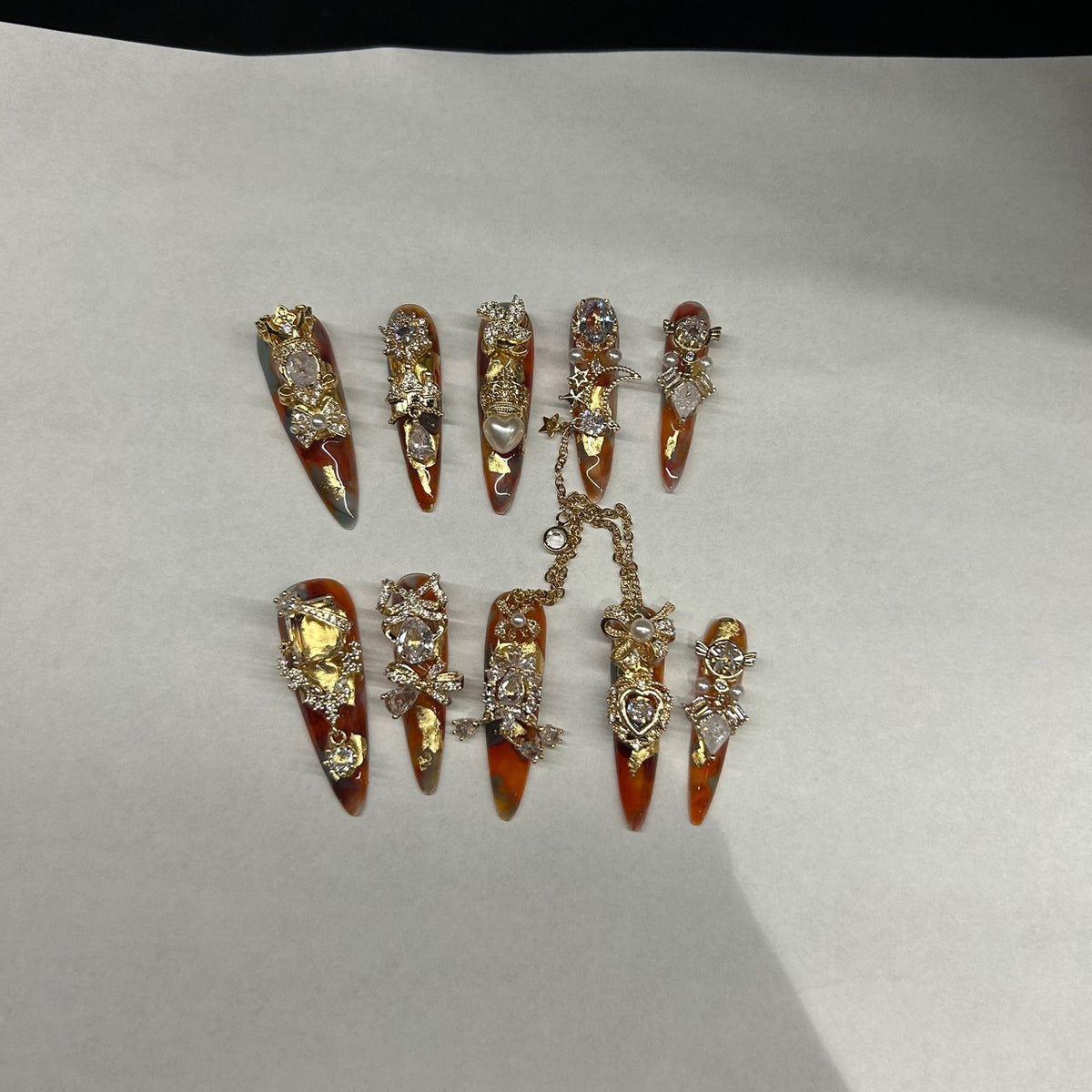 Handmade Amber Marble Long Stiletto Press On Nails with Gold Filigree, Crown & Large Crystal Charms