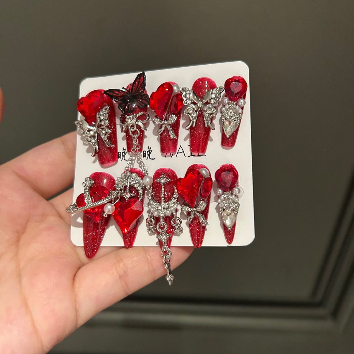 Handmade Sparkly Red Glitter Long Coffin Press On Nails with Giant Red Heart Crystals, Black & Silver Butterfly Charms, Saturn Ornaments & Silver Chain Tassels