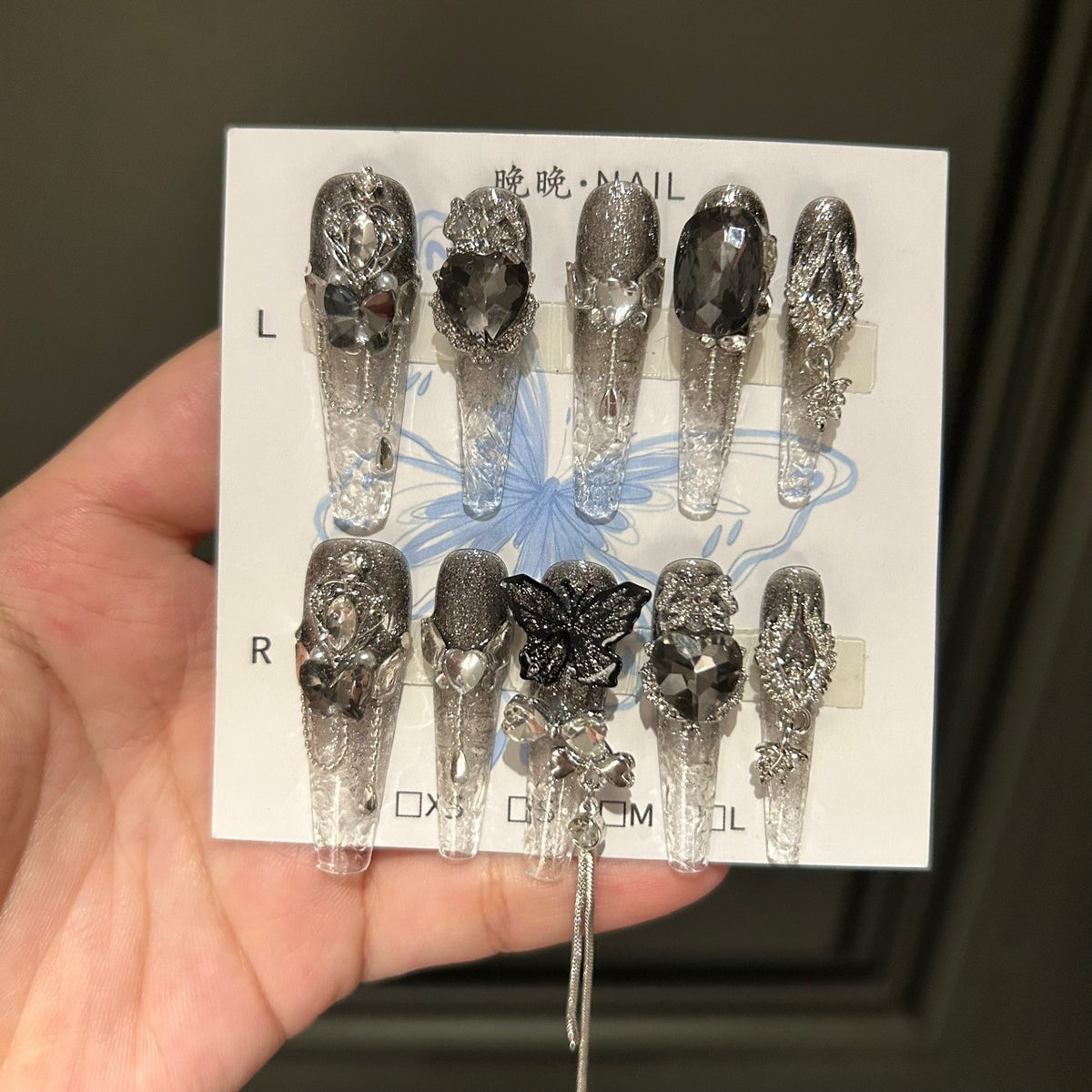 Handmade Clear Smoke Glitter Long Coffin Press On Nails with Giant Black Heart Crystals, Black Butterfly Charms, Silver Metal Ornaments & Dangling Tassel Chains