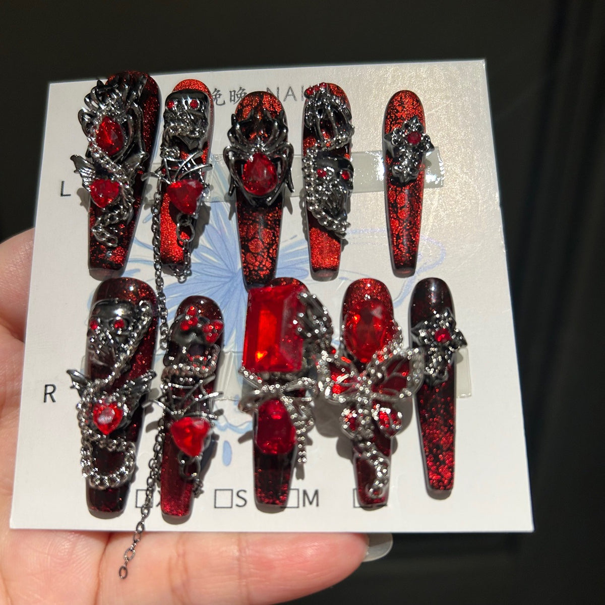 Handcrafted Designer Dark Aesthetic Press-on Nails - Shimmering Red-Black Base with Heavy 3D Gemstones, Skull Art and Chain Drops