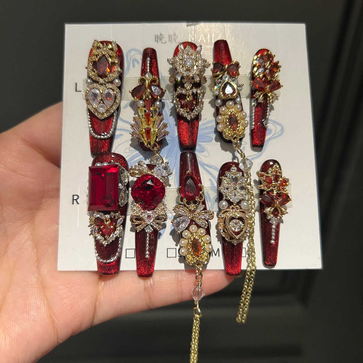 Handcrafted Designer Ruby Press-on Nails - Shimmering Cat Eye Base with Heavy 3D Red Gemstones, Gold Filigree and Chain Drops
