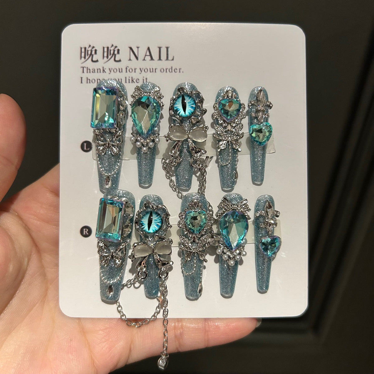 Icy Blue Cat Eye Coffin Press-on Nails with Oversized Iridescent Crystals, 3D Evil Eye, Bow, and Interlinked Chain - Y2K Cyber Glam Fake Nail Set