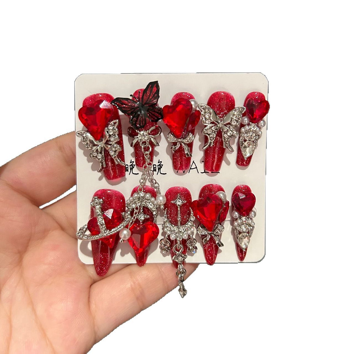 Handmade Sparkly Red Glitter Long Coffin Press On Nails with Giant Red Heart Crystals, Black & Silver Butterfly Charms, Saturn Ornaments & Silver Chain Tassels