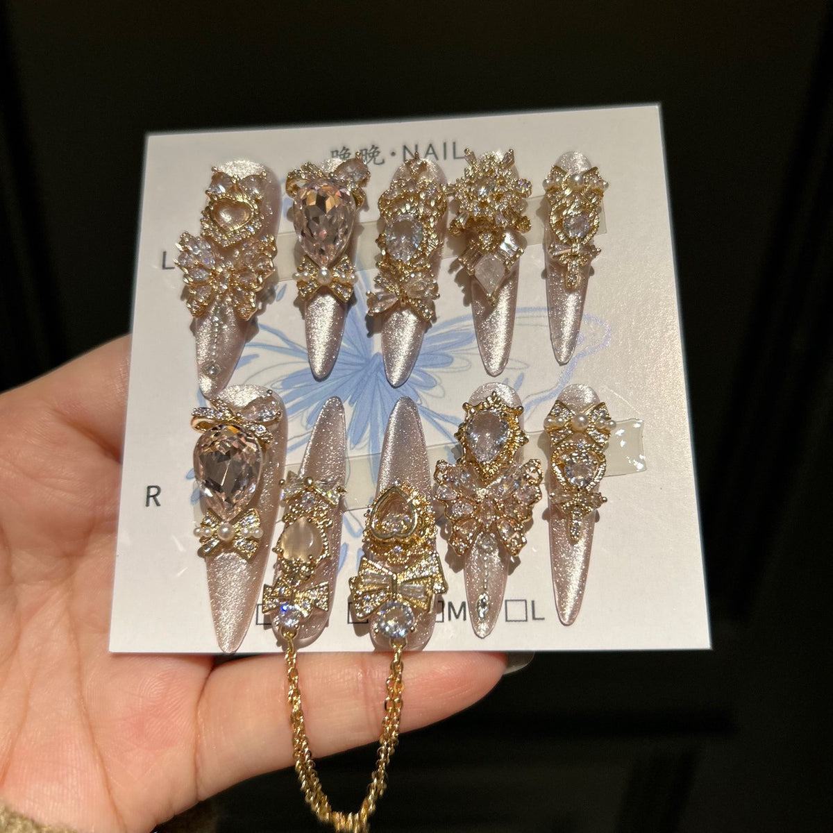 Champagne Pink Cat Eye Stiletto Press-on Nails with 3D Bowknot, Crystal Jewels, and Hanging Chain Charms - Luxury Statement Fake Nail Set