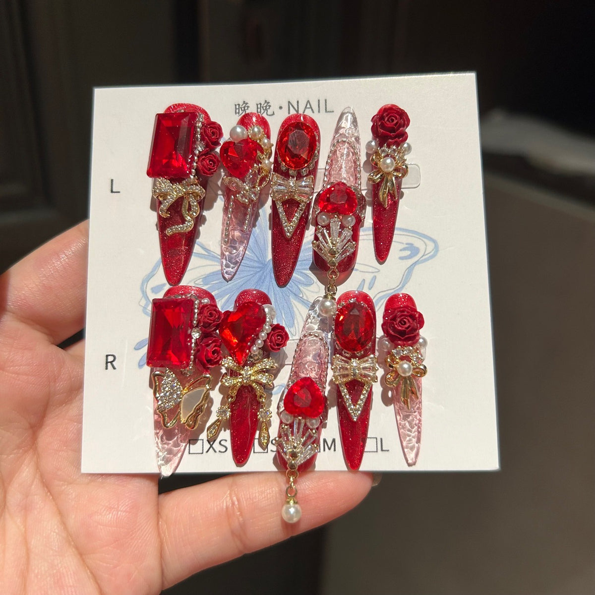 Ruby Red Cat Eye Stiletto Press-on Nails with 3D Rose, Crystal Rhinestone, and Hanging Chain Charms - Luxury Statement Fake Nail Set