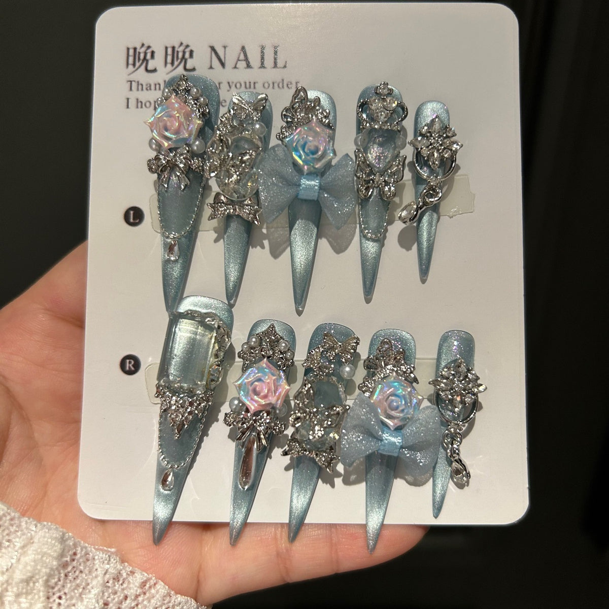 Handmade Ice Blue Cat Eye Long Stiletto Press On Nails with Iridescent 3D Roses, Glitter Bows, Butterfly Rhinestones, Pearls & Dangling Silver Chains