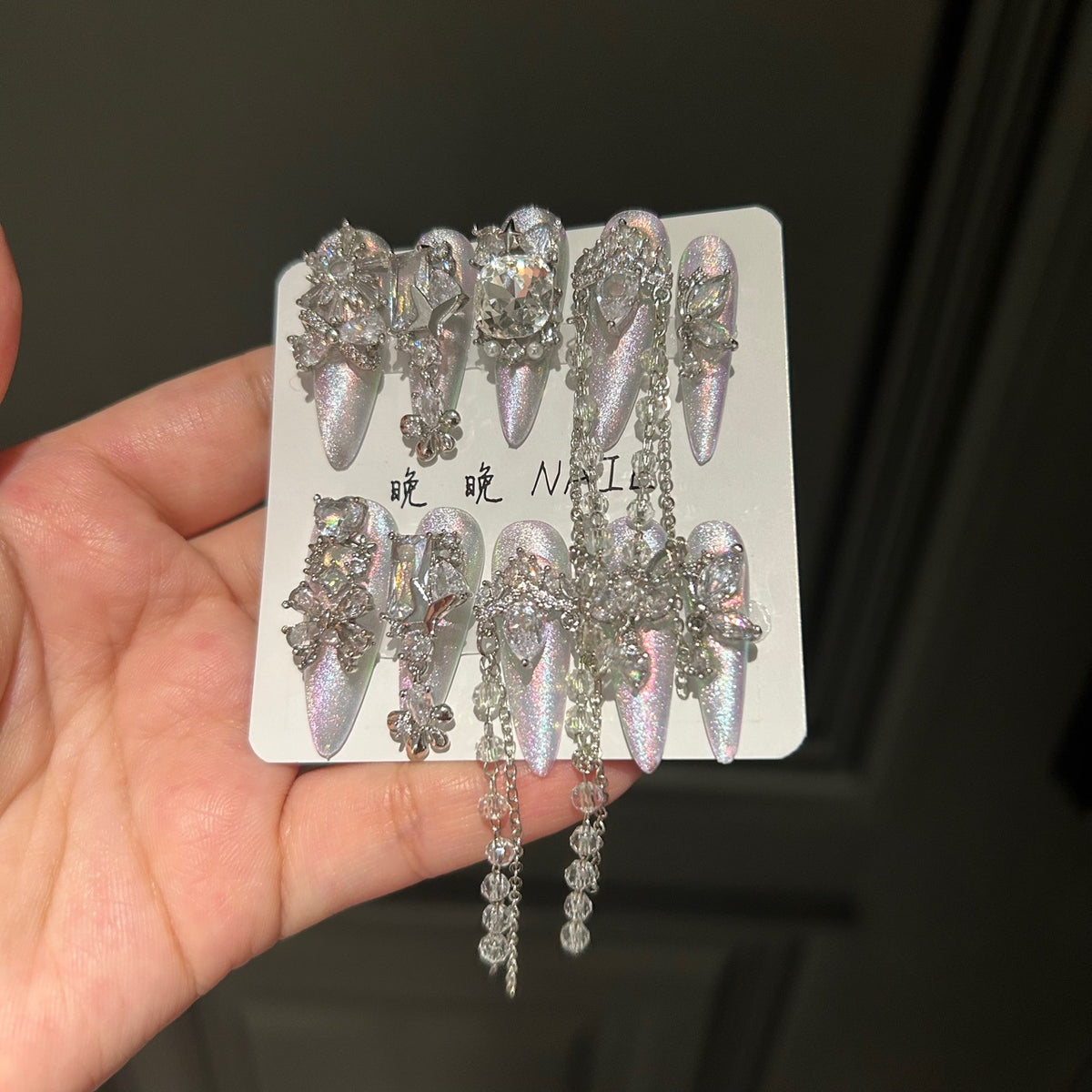 Holographic Silver Cat Eye Stiletto Press-on Nails with 3D Crystal Rhinestones, Over-sized Gem, and Beaded Hanging Chain Charms - Luxury Statement Fake Nail Set