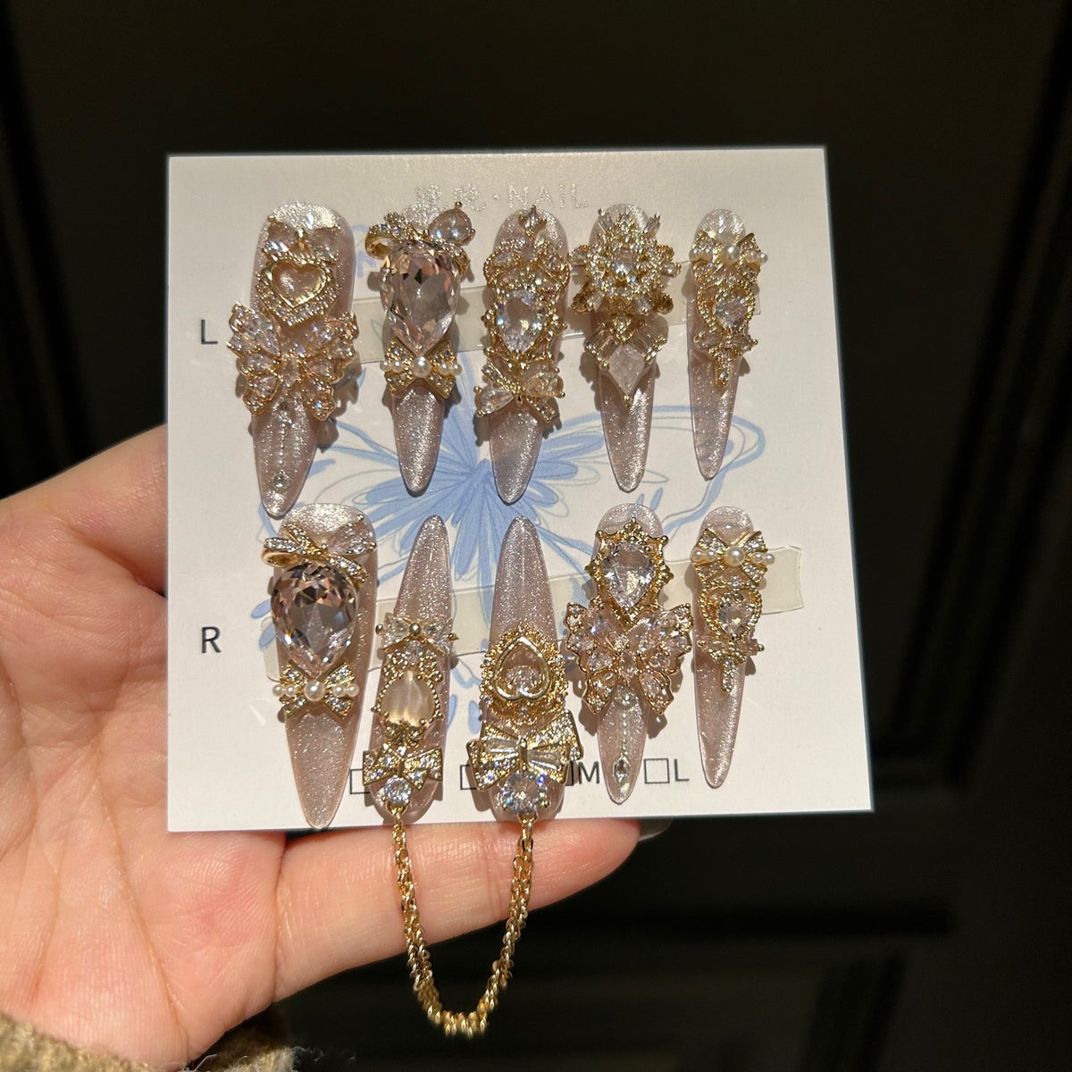Champagne Pink Cat Eye Stiletto Press-on Nails with 3D Bowknot, Crystal Jewels, and Hanging Chain Charms - Luxury Statement Fake Nail Set