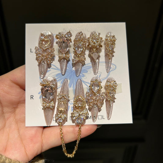 Champagne Pink Cat Eye Stiletto Press-on Nails with 3D Bowknot, Crystal Jewels, and Hanging Chain Charms - Luxury Statement Fake Nail Set