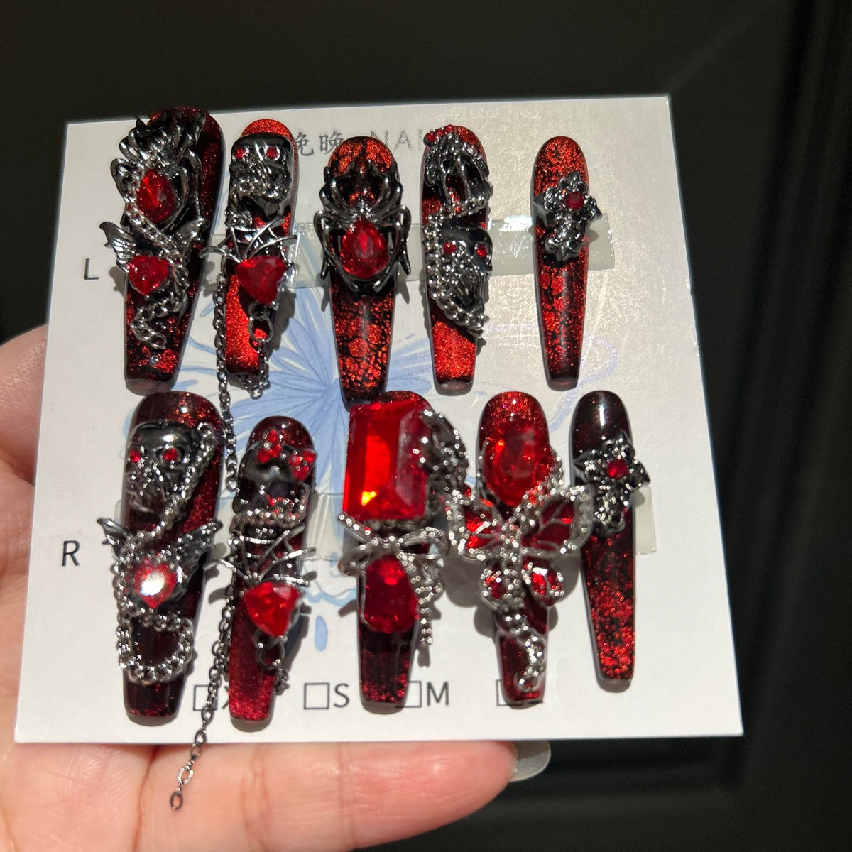 Handcrafted Designer Dark Aesthetic Press-on Nails - Shimmering Red-Black Base with Heavy 3D Gemstones, Skull Art and Chain Drops