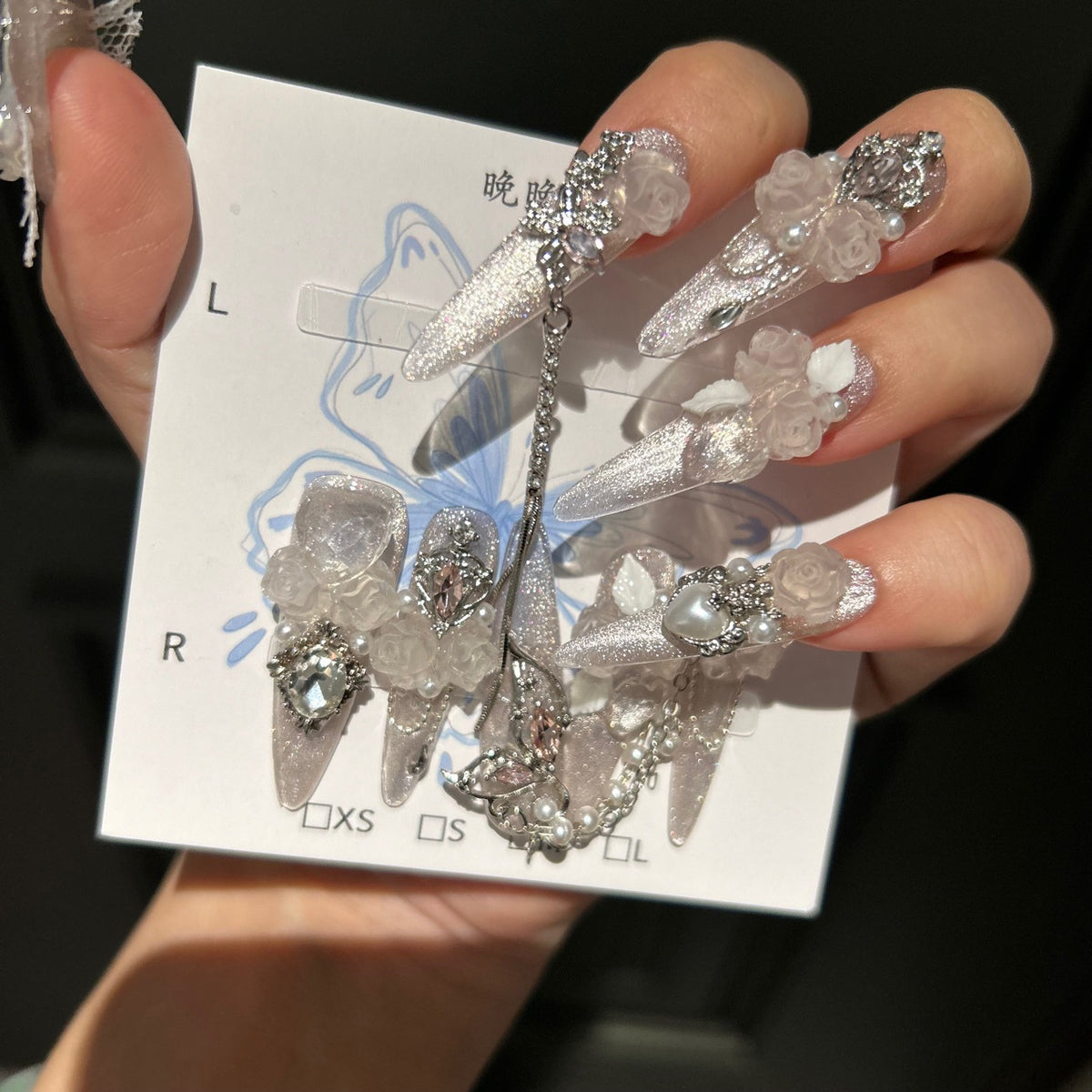 Handmade Milky Silver Cat Eye Long Stiletto Press On Nails with Frosted 3D White Roses, Butterfly Charms, Heart Crystals & Pearl Chain Tassels