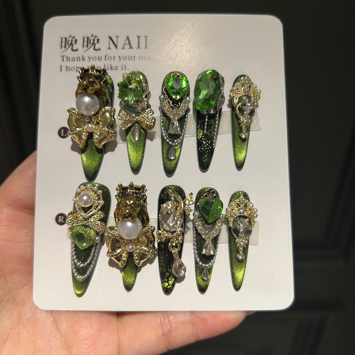 Handmade Green Cat Eye Press On Nails, Long Stiletto Royal Fantasy False Nails with Gold Lion Head & Crown Charms, Emerald Green Rhinestones, Pearls, Gold Bows & Dangling Silver Chains, Reusable Fake Nails for Party & Cosplay