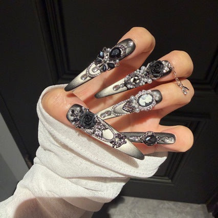 Handmade Black Silver Ombre Long Stiletto Press On Nails. Dark romantic gothic false nails decorated with 3D black roses, vintage cameo portrait, black gems, pearls, silver rhinestones and dangling silver chains.