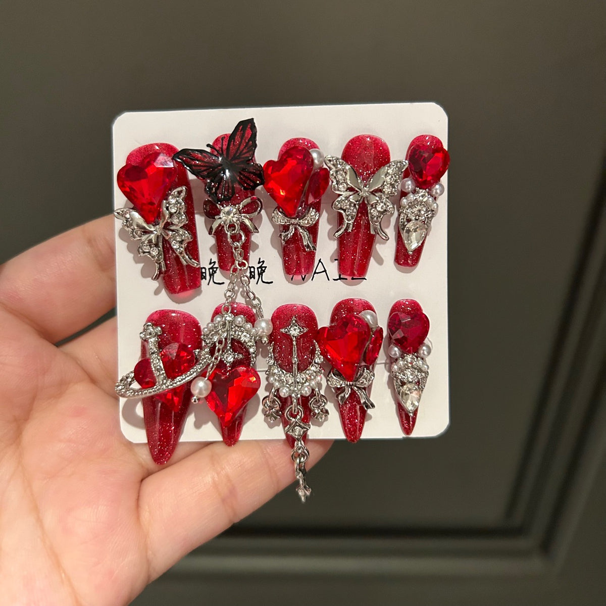 Handmade Sparkly Red Glitter Long Coffin Press On Nails with Giant Red Heart Crystals, Black & Silver Butterfly Charms, Saturn Ornaments & Silver Chain Tassels
