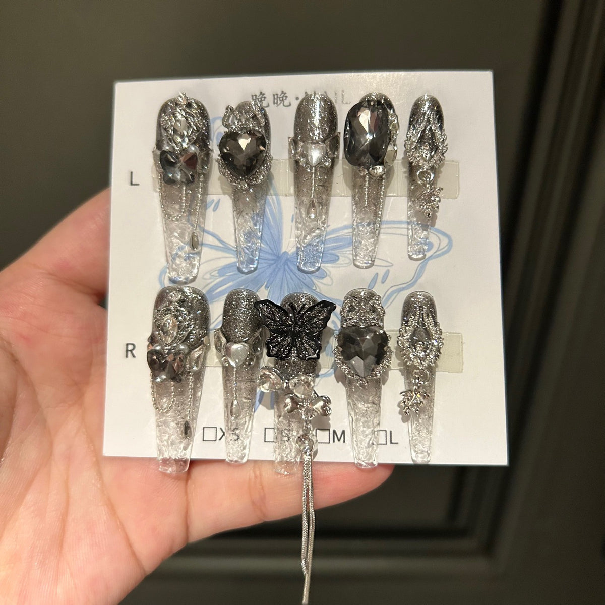 Handmade Clear Smoke Glitter Long Coffin Press On Nails with Giant Black Heart Crystals, Black Butterfly Charms, Silver Metal Ornaments & Dangling Tassel Chains
