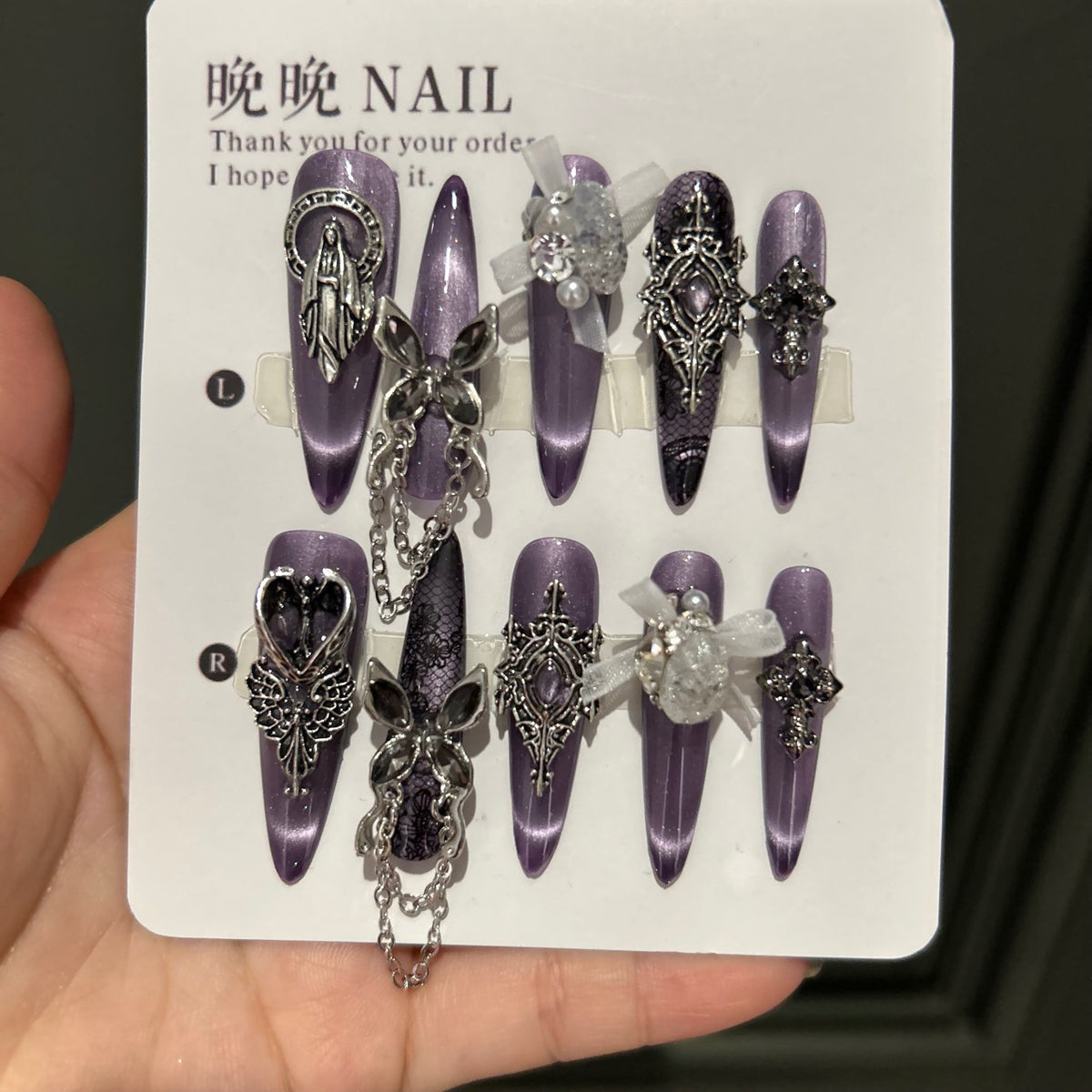 Dark Grey-Purple Cat Eye Stiletto Press-on Nails with Vintage Silver Religious Relief, Lace Pattern, White Ribbon Bow, Butterfly, and Draping Chain - Gothic Glam Fake Nail Set