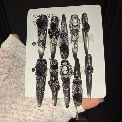 Handmade Black Silver Ombre Long Stiletto Press On Nails. Dark romantic gothic false nails decorated with 3D black roses, vintage cameo portrait, black gems, pearls, silver rhinestones and dangling silver chains.