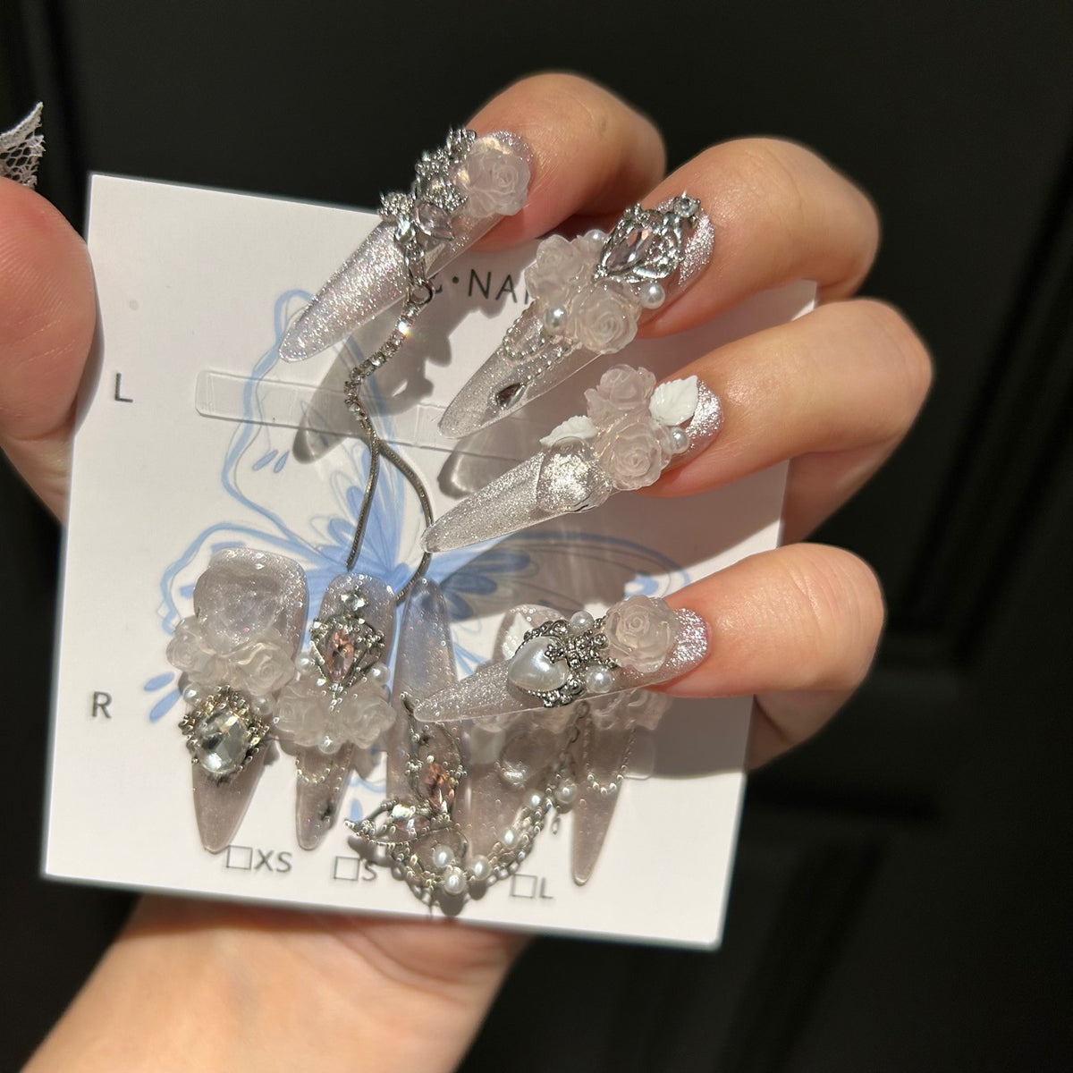 Handmade Milky Silver Cat Eye Long Stiletto Press On Nails with Frosted 3D White Roses, Butterfly Charms, Heart Crystals & Pearl Chain Tassels