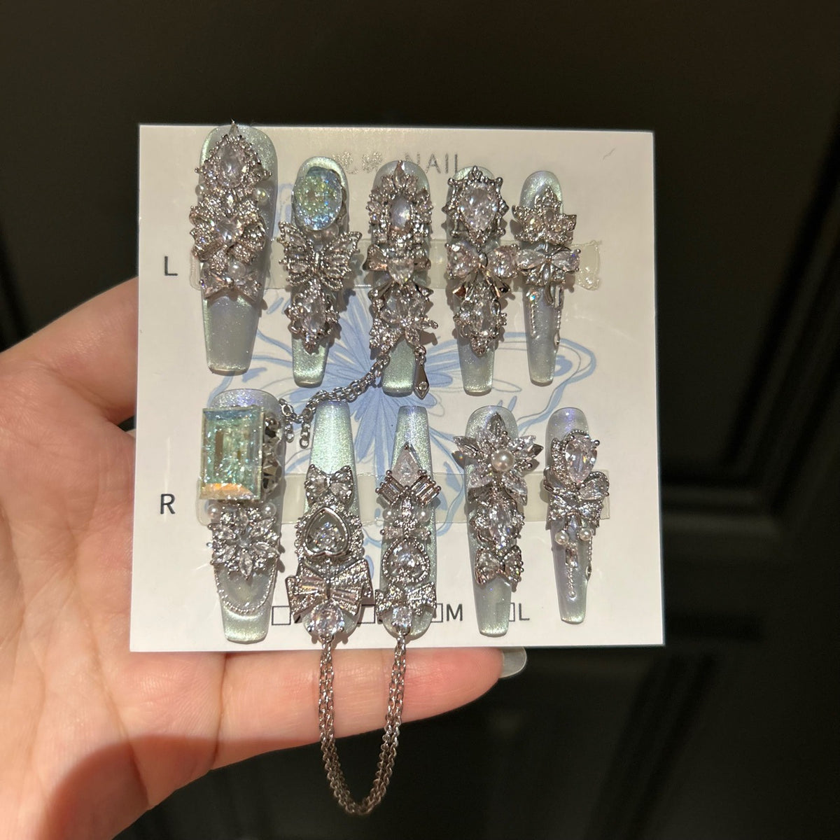 Silver Blue Cat Eye Coffin Press-on Nails with Over-sized Crystal Gems, Bowknot, and Interlinked Hanging Chain - Luxury Glam Fake Nail Set