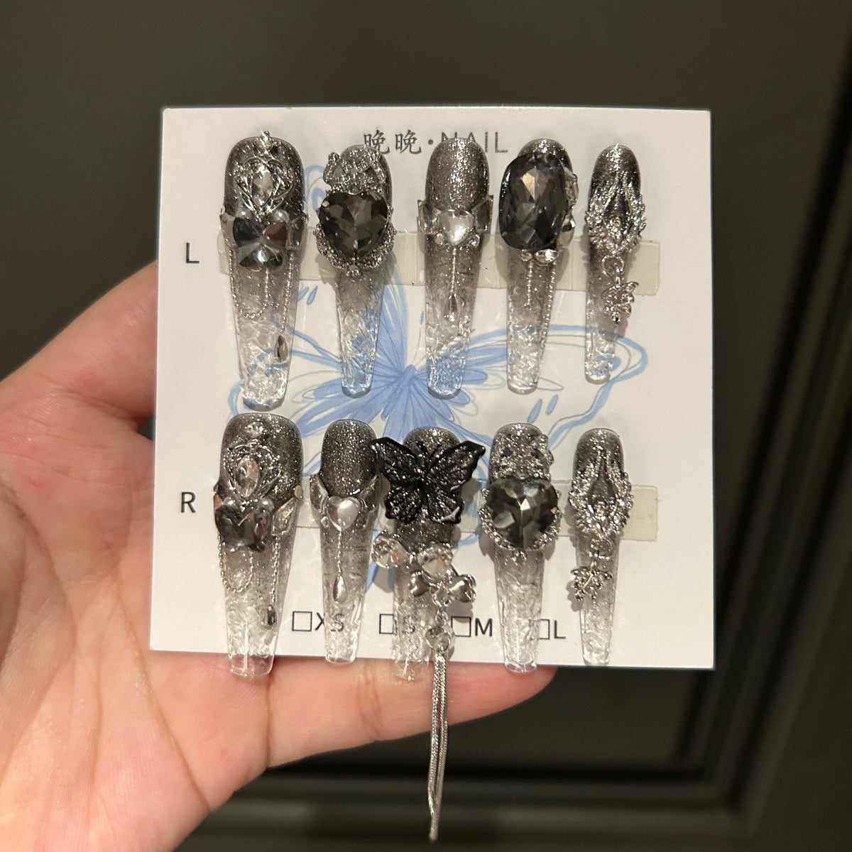 Handmade Clear Smoke Glitter Long Coffin Press On Nails with Giant Black Heart Crystals, Black Butterfly Charms, Silver Metal Ornaments & Dangling Tassel Chains