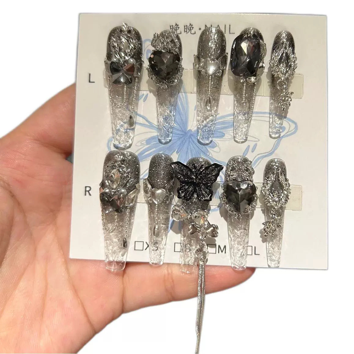 Handmade Clear Smoke Glitter Long Coffin Press On Nails with Giant Black Heart Crystals, Black Butterfly Charms, Silver Metal Ornaments & Dangling Tassel Chains