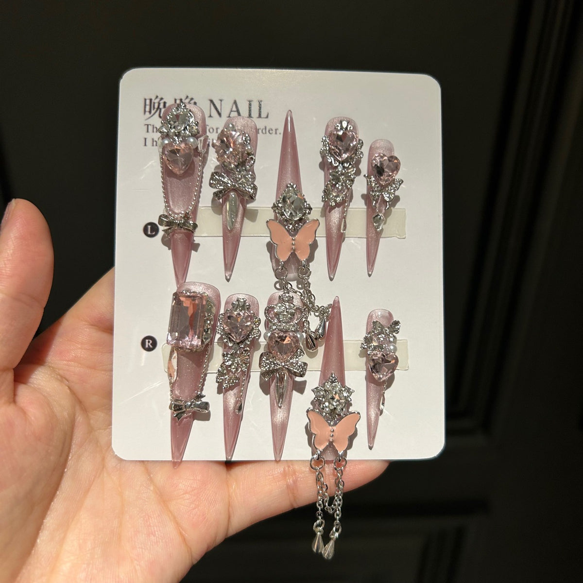 Handmade Soft Nude Pink Press On Nails, Long Stiletto Princess False Nails with Pink Heart Rhinestones, 3D Butterfly, Silver Bow Charms, Pearls & Dangling Silver Chain, Reusable Fake Nails for Wedding & Party