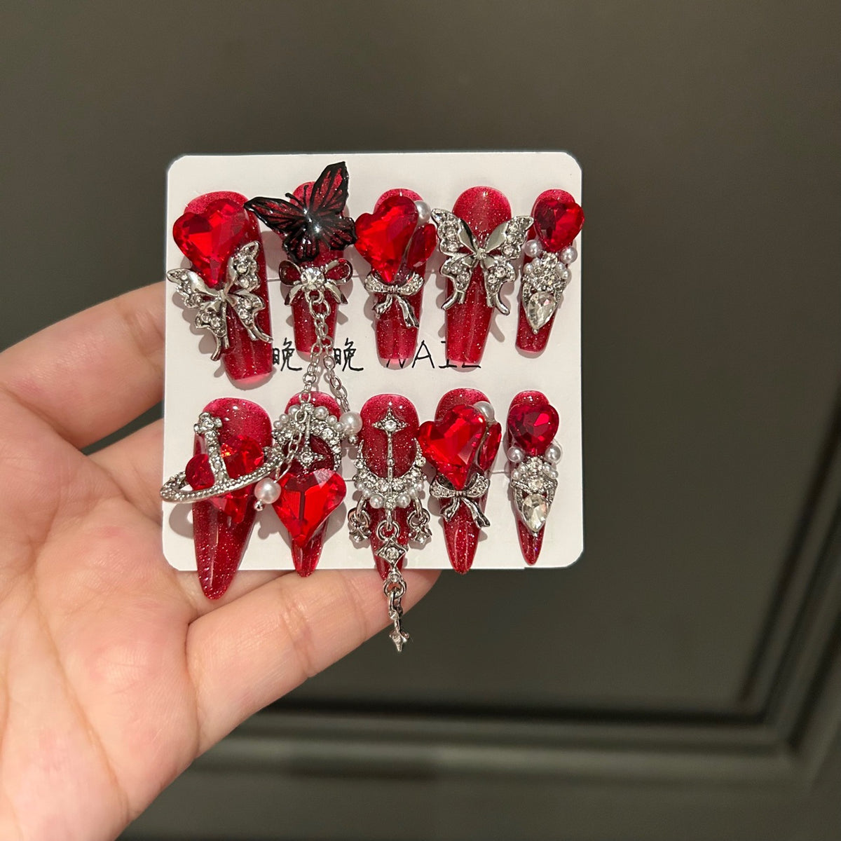 Handmade Sparkly Red Glitter Long Coffin Press On Nails with Giant Red Heart Crystals, Black & Silver Butterfly Charms, Saturn Ornaments & Silver Chain Tassels