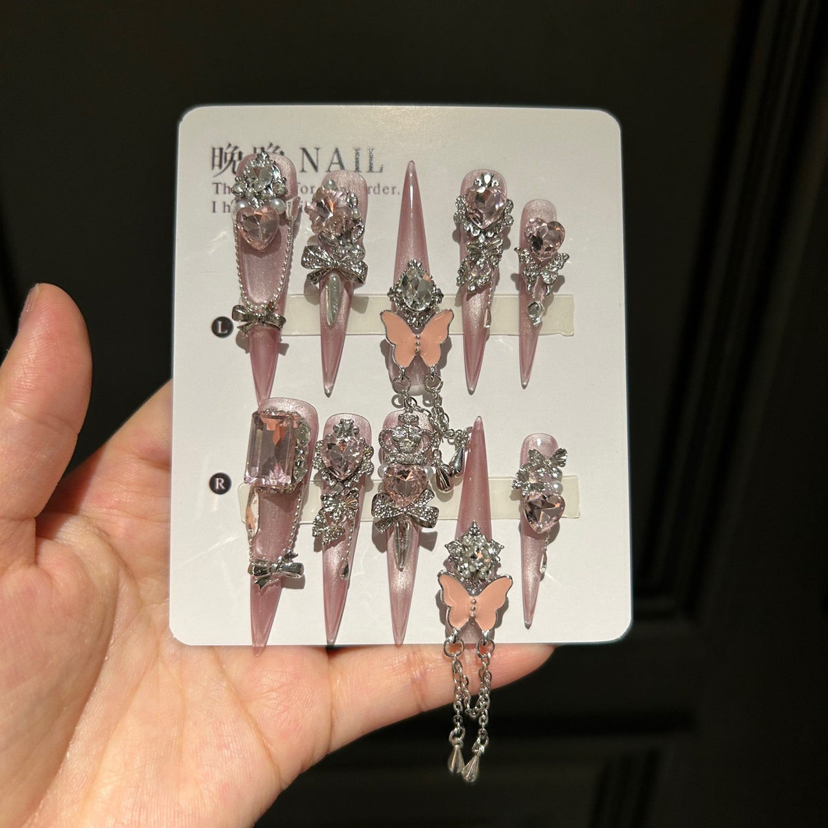 Handmade Soft Nude Pink Press On Nails, Long Stiletto Princess False Nails with Pink Heart Rhinestones, 3D Butterfly, Silver Bow Charms, Pearls & Dangling Silver Chain, Reusable Fake Nails for Wedding & Party