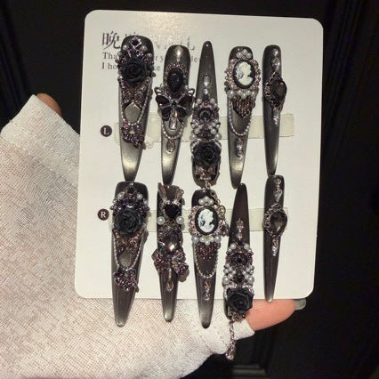 Handmade Black Silver Ombre Long Stiletto Press On Nails. Dark romantic gothic false nails decorated with 3D black roses, vintage cameo portrait, black gems, pearls, silver rhinestones and dangling silver chains.