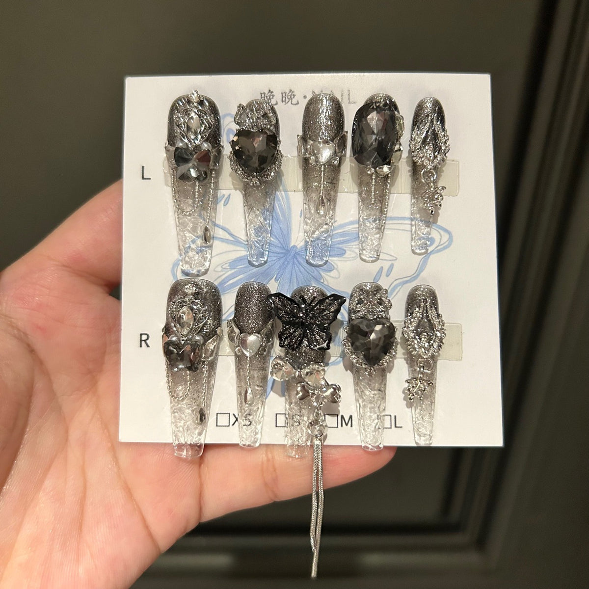 Handmade Clear Smoke Glitter Long Coffin Press On Nails with Giant Black Heart Crystals, Black Butterfly Charms, Silver Metal Ornaments & Dangling Tassel Chains