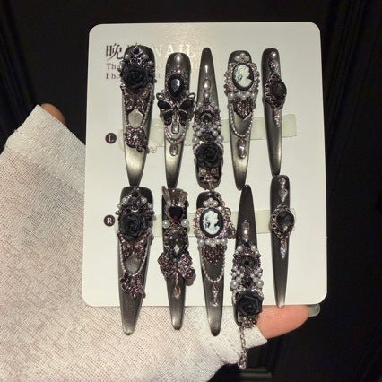 Handmade Black Silver Ombre Long Stiletto Press On Nails. Dark romantic gothic false nails decorated with 3D black roses, vintage cameo portrait, black gems, pearls, silver rhinestones and dangling silver chains.